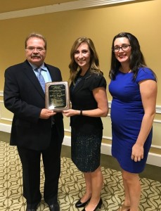 Jeffrey Barnhart, president and CEO of Creative Marketing Alliance, Tana Smith, principal, Hopewell Valley Central High School, and Erin Klebaur, director of marketing services at Creative Marketing Alliance, after he was introduced as a Distinguished Graduate on October 20.